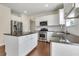 Well-lit kitchen featuring granite countertops, stainless appliances, and a kitchen island at 213 Roseman Way, Woodstock, GA 30188