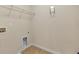 Empty laundry room with tile flooring and wall mounted shelving at 213 Roseman Way, Woodstock, GA 30188