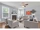 Cozy living room with fireplace, two chairs, sectional couch, and light-colored walls at 213 Roseman Way, Woodstock, GA 30188