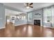 Open floorplan with hardwood floors, fireplace, and view into the kitchen at 213 Roseman Way, Woodstock, GA 30188