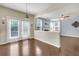 Living room has light colored walls, wood floors, and access to the kitchen and patio at 213 Roseman Way, Woodstock, GA 30188