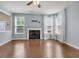 Living room has wood floors, a fireplace, a ceiling fan, and lots of light at 213 Roseman Way, Woodstock, GA 30188
