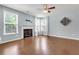 Living room with fireplace, ceiling fan, wood floors, and light-colored walls at 213 Roseman Way, Woodstock, GA 30188