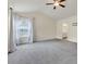 Spacious main bedroom featuring a ceiling fan, lots of natural light and neutral carpet at 213 Roseman Way, Woodstock, GA 30188