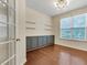 Cozy office space with built-in cabinets, shelving, and a large window at 213 Roseman Way, Woodstock, GA 30188