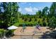 Community playground with swings, slides, and climbing structures surrounded by lush greenery at 213 Roseman Way, Woodstock, GA 30188