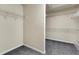 Walk-in closet features ample storage space with multiple shelves and a neutral carpet at 213 Roseman Way, Woodstock, GA 30188