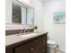 Updated bathroom features a dark vanity, granite countertop, and stylish mirror at 3617 Lassiter Rd, Marietta, GA 30062