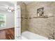 Elegant bathroom shower and bathtub combination with decorative tilework at 3617 Lassiter Rd, Marietta, GA 30062