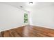 Bright bedroom with hardwood floors, ceiling fan and view to the exterior at 3617 Lassiter Rd, Marietta, GA 30062