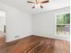 Bright bedroom with hardwood floors, ceiling fan and a view to the exterior at 3617 Lassiter Rd, Marietta, GA 30062