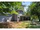 Exterior view of home featuring large windows, back porch, stone firepit and ample yard space at 3617 Lassiter Rd, Marietta, GA 30062