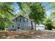 Charming blue home with attached garage and mature trees in the front yard at 3617 Lassiter Rd, Marietta, GA 30062