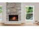 Close up view of a stone fireplace and hardwood floors in the living room at 3617 Lassiter Rd, Marietta, GA 30062