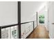 Second story hallway with hardwood floors and white and black accents at 3617 Lassiter Rd, Marietta, GA 30062