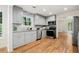 Updated kitchen features stainless steel appliances, granite countertops, and gray cabinets at 3617 Lassiter Rd, Marietta, GA 30062