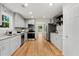 Modern kitchen with stainless steel appliances, granite countertops, and hardwood floors at 3617 Lassiter Rd, Marietta, GA 30062