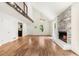 Open living room featuring hardwood floors, stone fireplace, and open layout at 3617 Lassiter Rd, Marietta, GA 30062