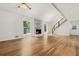 Spacious living room with hardwood floors, fireplace, and staircase to the second floor at 3617 Lassiter Rd, Marietta, GA 30062