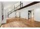 Open living room with hardwood floors, stone fireplace, and access to kitchen at 3617 Lassiter Rd, Marietta, GA 30062