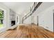 Bright living room featuring hardwood floors, fireplace, and staircase to the second floor at 3617 Lassiter Rd, Marietta, GA 30062