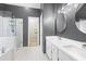 Stylish bathroom with a glass-enclosed shower, double sink vanity, and modern fixtures, enhanced by hexagonal floor tiles at 3793 Market Cres, Clarkston, GA 30021