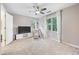 Inviting bedroom with soft carpet, TV, ceiling fan, and natural light coming in through the window at 3793 Market Cres, Clarkston, GA 30021