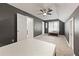 Spacious bedroom with gray walls, a ceiling fan, neutral carpet, and ample natural light from the window at 3793 Market Cres, Clarkston, GA 30021