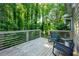 Back deck with 2 chairs overlooking a lush, green treed backyard at 3793 Market Cres, Clarkston, GA 30021