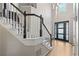 Welcoming two-story entryway with hardwood floors, a staircase with black banister, and modern front door with glass panels at 3793 Market Cres, Clarkston, GA 30021