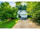 Charming home with a well-manicured lawn and an attached garage, framed by lush green trees, offering great curb appeal at 3793 Market Cres, Clarkston, GA 30021