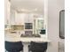 Stylish kitchen featuring a breakfast bar with stools, stainless steel appliances, and elegant white cabinets at 3793 Market Cres, Clarkston, GA 30021