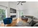 Bright living room with high ceilings, a modern fireplace, hardwood floors, and comfortable seating arrangement at 3793 Market Cres, Clarkston, GA 30021