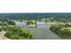 Aerial view of a lake with a golf course and residential homes among lush greenery at 915 Sundown Pt, Villa Rica, GA 30180