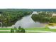 Tranquil aerial view of a lake surrounded by a lush golf course and green landscape at 915 Sundown Pt, Villa Rica, GA 30180