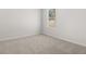 Bright bedroom with neutral carpet and trim, and a window with a view of trees at 915 Sundown Pt, Villa Rica, GA 30180