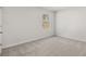 Bedroom with neutral carpet and trim, and a window with a view of trees at 915 Sundown Pt, Villa Rica, GA 30180