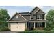 Charming two-story home with a two-car garage, covered entry, and beautifully landscaped front yard at 915 Sundown Pt, Villa Rica, GA 30180