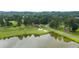 Scenic view of the golf course with a pond, sand traps, and lush greenery at 915 Sundown Pt, Villa Rica, GA 30180