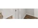 A hallway features light hardwood flooring, white walls with baseboards, and a white door at 915 Sundown Pt, Villa Rica, GA 30180