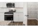 Modern kitchen featuring stainless steel appliances, subway tile backsplash, and a convenient walk-in pantry at 915 Sundown Pt, Villa Rica, GA 30180