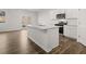Open-concept kitchen with a large island, stainless steel appliances, and hardwood floors, perfect for entertaining at 915 Sundown Pt, Villa Rica, GA 30180