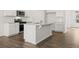Contemporary kitchen with a center island, stainless steel appliances, and hardwood floors at 915 Sundown Pt, Villa Rica, GA 30180