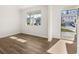 Sunlit living room with hardwood floors and a large window offering scenic views of the neighborhood at 915 Sundown Pt, Villa Rica, GA 30180