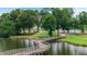 Scenic winding wooden bridge across a calm lake, surrounded by lush greenery and a golf course at 915 Sundown Pt, Villa Rica, GA 30180