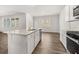 Open kitchen with granite countertops, stainless steel appliances, and ample natural light at 917 Sundown Pt, Villa Rica, GA 30180