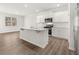 Modern kitchen with granite countertops, a central island, and stainless steel appliances at 917 Sundown Pt, Villa Rica, GA 30180