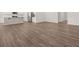 Bright open living room featuring luxury vinyl plank floors and modern kitchen view at 917 Sundown Pt, Villa Rica, GA 30180