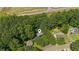 Aerial view of the home's location nestled among mature trees, with other homes nearby at 202 Cedar Valley Ct, Canton, GA 30115
