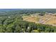Aerial view of home surrounded by lush trees and nearby new community at 202 Cedar Valley Ct, Canton, GA 30115